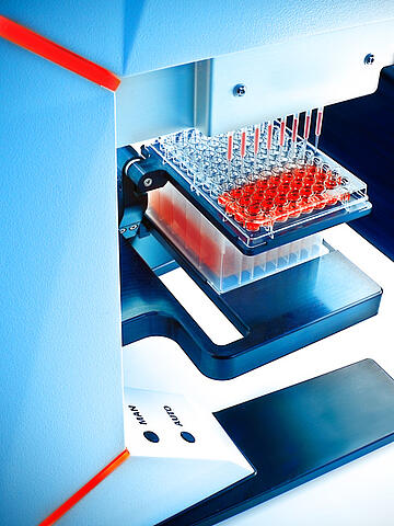 a CyBio SELMA 96-channel pipettor holding 8 tips after aspirating red liquid from a 96-well plate