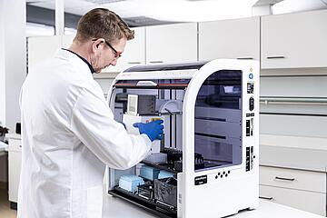 a person changing the pipetting head on a CyBio Felix liquid handler