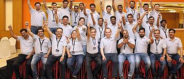 Team Photo AJ Instruments India Pvt Ltd. with raised fists