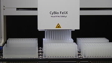 A CyBio Felix liquid handling robot performing a protein purification step by pipetting into a deep well plate with Phynexus 96 tips.